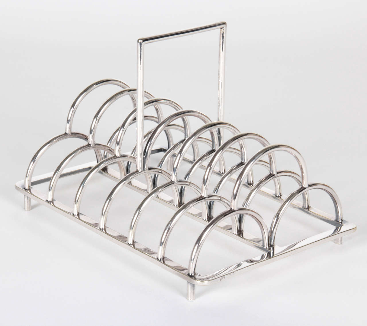 CHRISTOPHER DRESSER  (1834-1904)  UK
JAMES DIXON & SONS Sheffield, England

“Triple Arch” square handle toast rack circa 1881

Silver-plate 

Marks: JD&S (stamped), Chr. Dresser (facsimile signature), EP, #67, diamond or clover