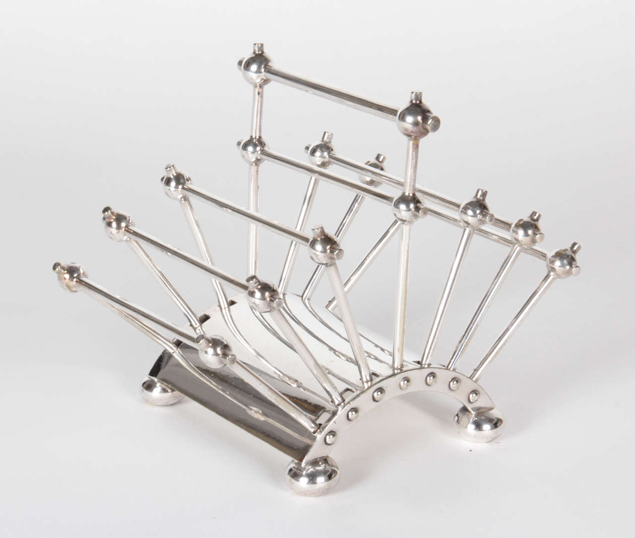 CHRISTOPHER DRESSER  (1834-1904)  UK
HUKIN & HEATH   Birmingham, England

Adjustable toast or letter rack 1881

Silver-plate (articulated model)

Marks: H&H, 2555, stylized fleur-de-lis touch mark

There is another model of this toast