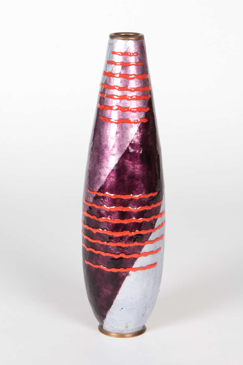 JULES SARLANDIE  (1874-1936) France
RENÉ CREVEL [decorator]
LIMOGES  Paris, France

Vase c. 1930

Enameled copper and bronze with a twisting stripe design of platinum, light and dark purple with intermittent brilliant red graphic wavy band