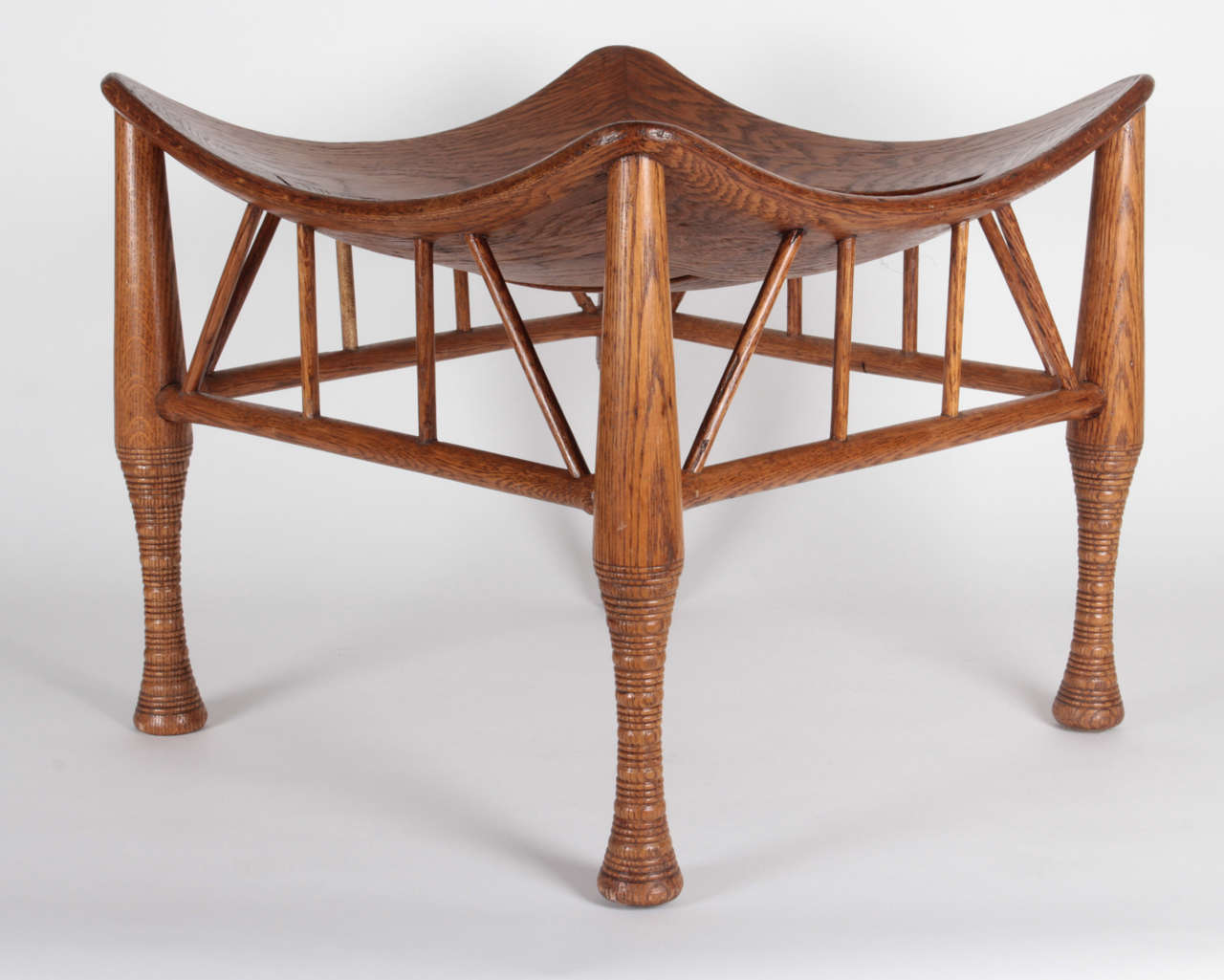 Leonard Wyburd UK.
Liberty & Company London.

Four-legged Thebes stool circa 1890-1895. Oak with highly figured grain, concave slat seat, turned details.

Marks: 4 (impressed on underside).

This design was registered by Liberty & Co. in