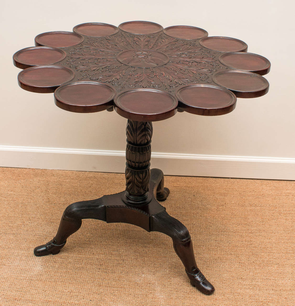 Mahogany tripod tilt-top supper table, heavily carved top standing on the well know Isle of Man feet<br />
<br />
