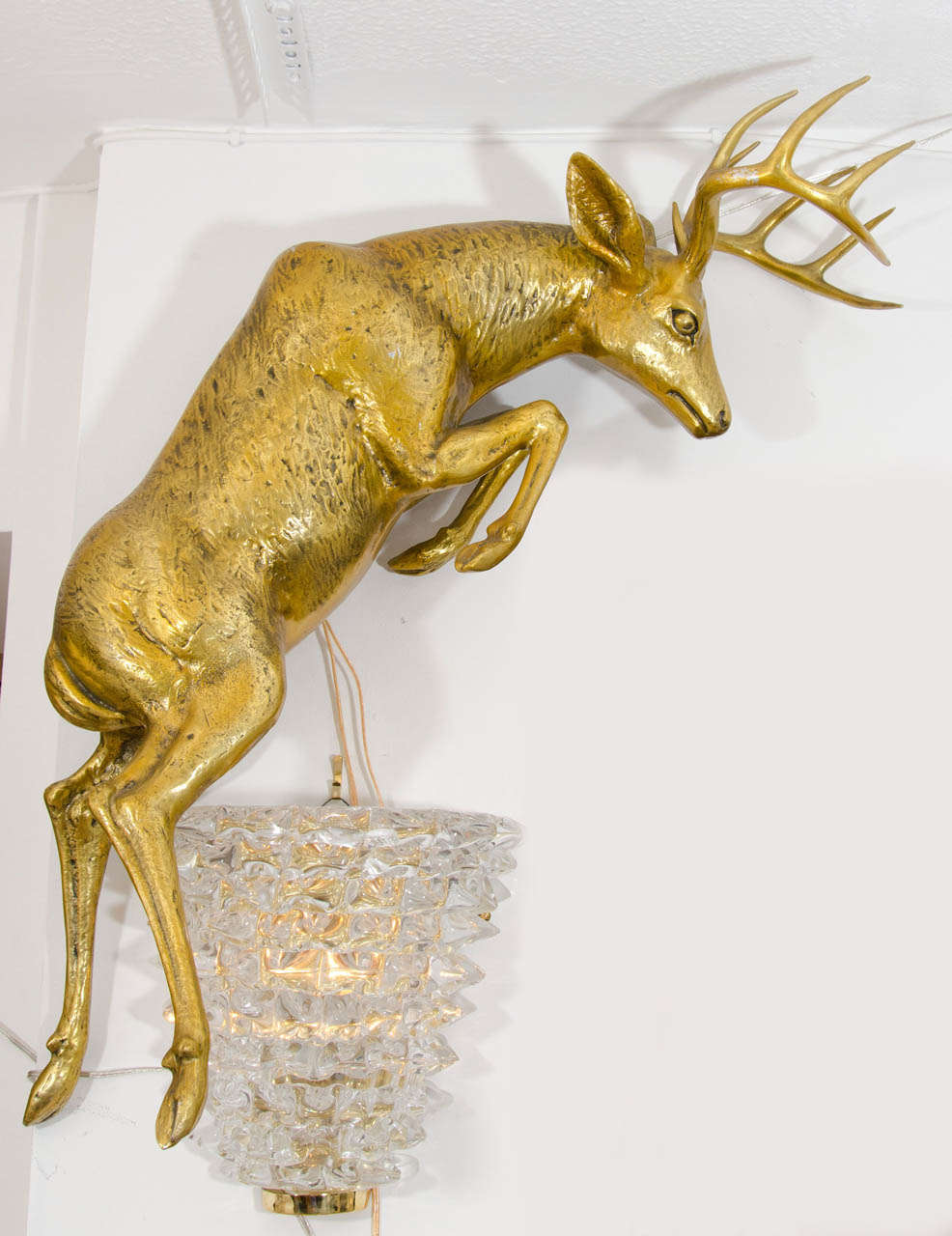 Pair of gilt aluminum, wall mounted deer sculptures.<br />
<br />
