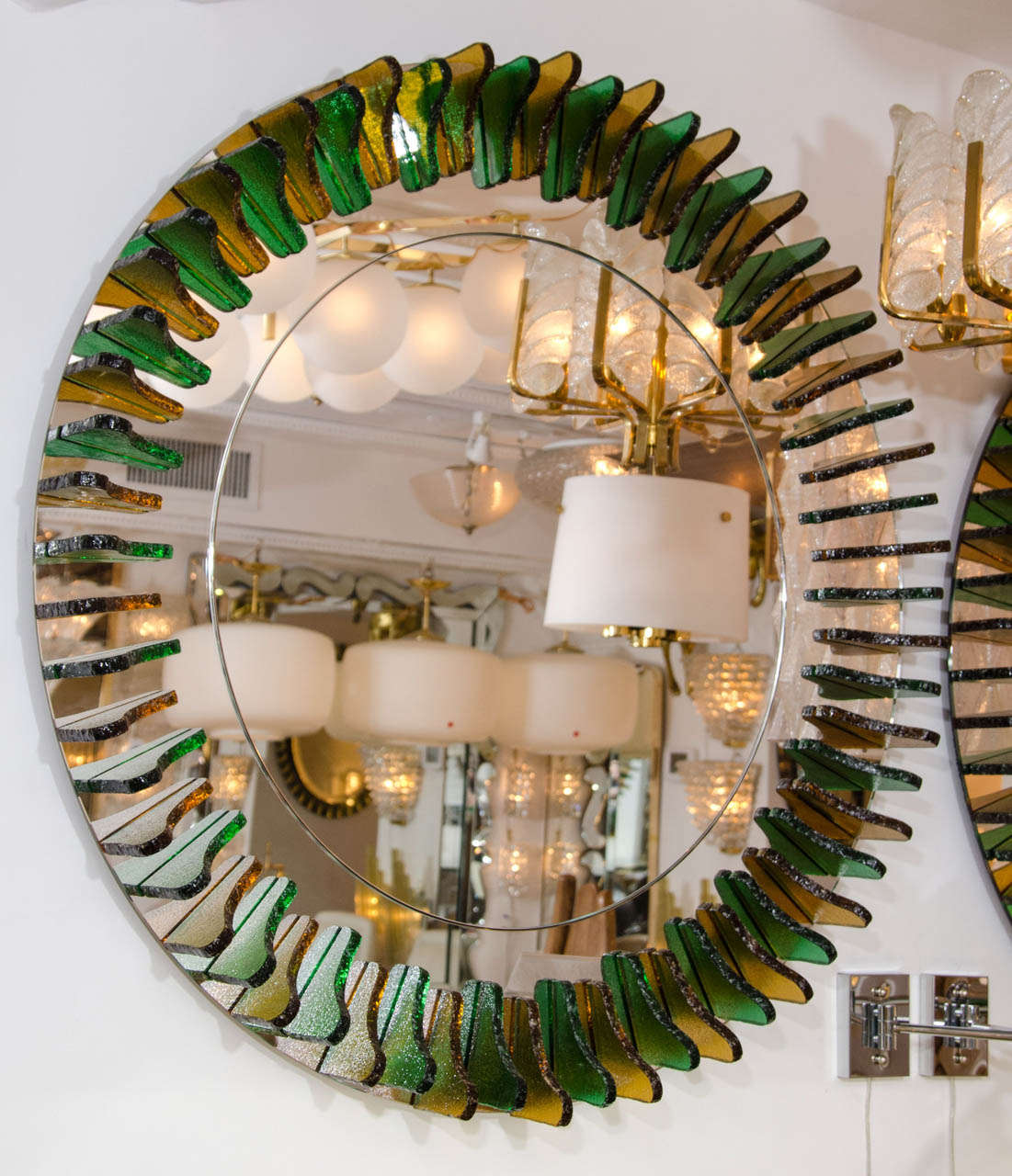 Large girasole style mirror with alternating green and amber glass fragment surround.