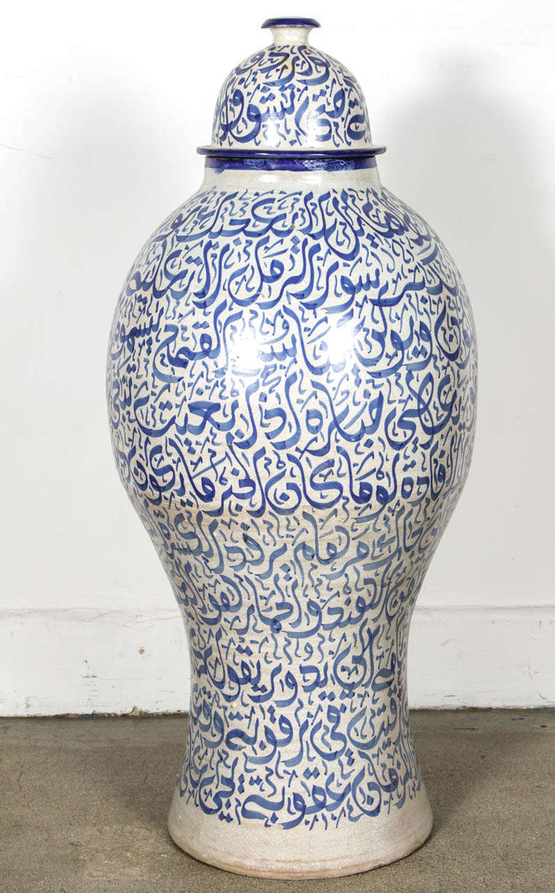 Moroccan Calligraphic Style Blue Urn 3 feet High.
Hispano Moresque large ceramic with Arabic calligraphy writing in the Ottoman style. 
Moroccan Ceramic jar from fez with lid 3 feet high.
Blue calligraphy scripts designs on white pottery Urn from