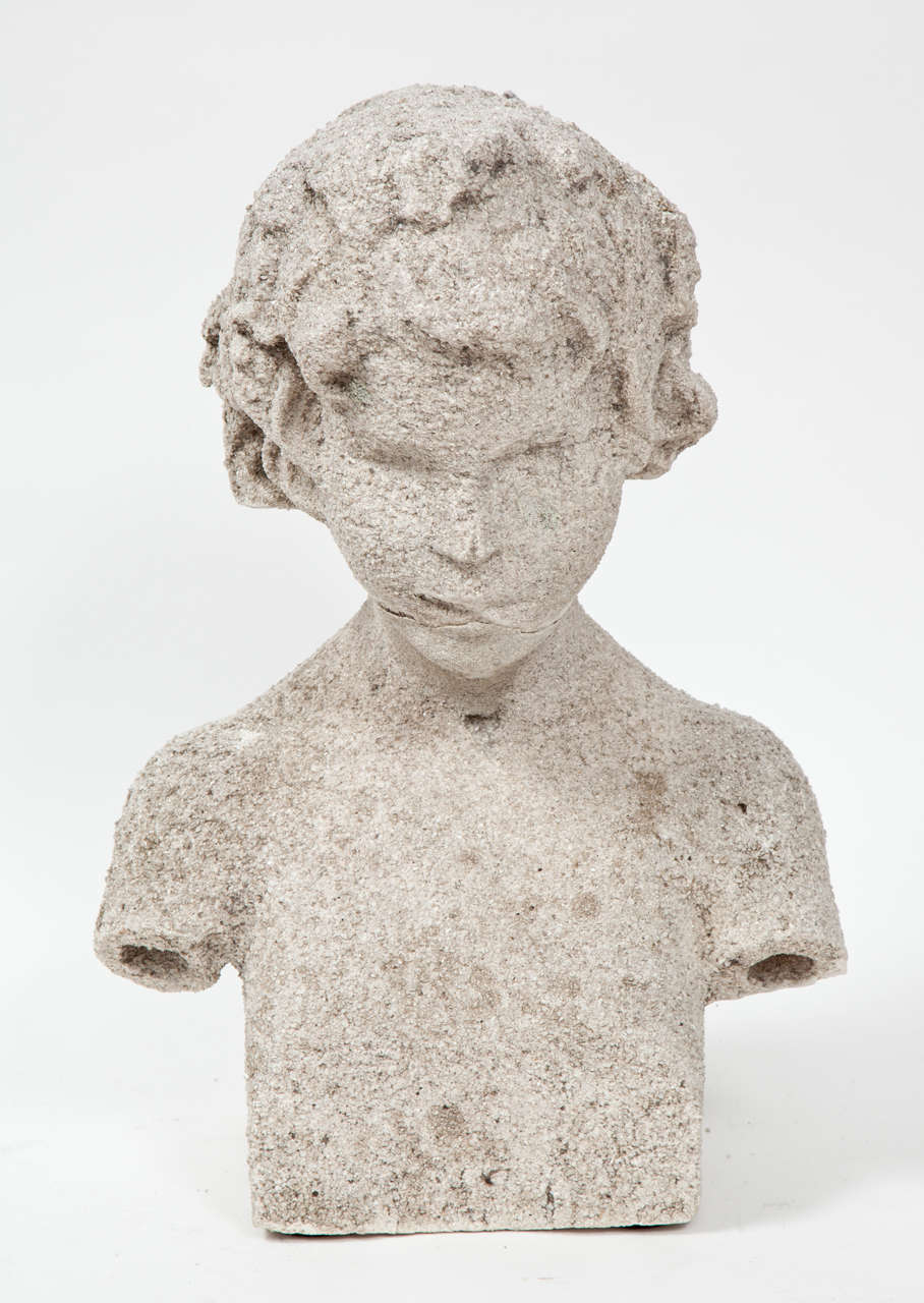 A bust of a young boy in limestone, circa 1900.