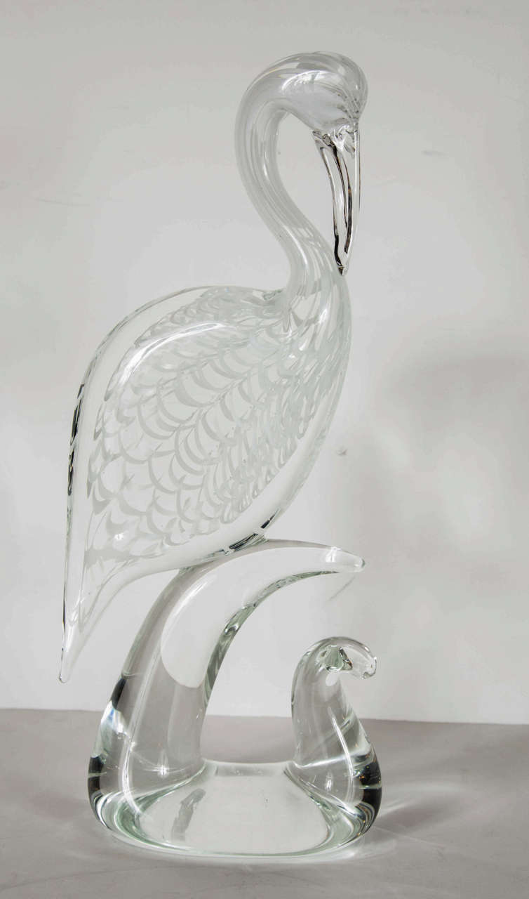 Stunning handblown Murano glass crane sculpture signed by Licio Zanetti. This Murano glass sculpture is of a crane perched atop an organic, free-form structure reminiscent of the fluidity of water. The crane itself is has been handblown with a