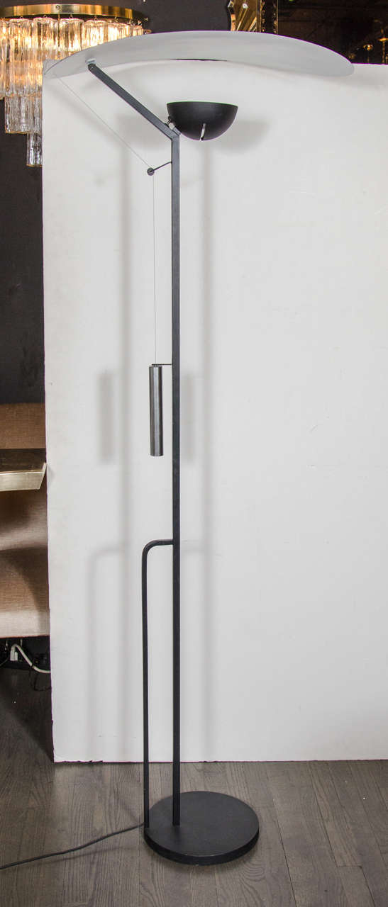 Mid-Century Modernist cantilever floor lamp by Patrick Naggar in a chic black powder coated steel. This exquisite floor lamp starts with a round base that supports the lamps main stem with a secondary support on the back that offers structure for