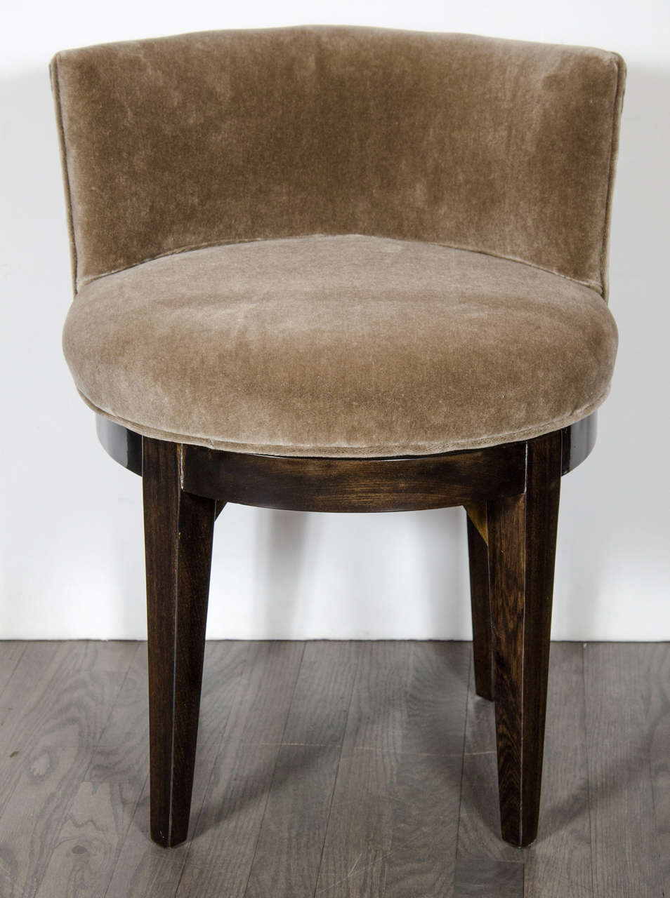 This elegant Art Deco Vanity stool features an upholstered swivel seat with lumbar support in smoked topaz mohair, the base is ebonized walnut with sturdy tapered legs. Restored to mint condition.