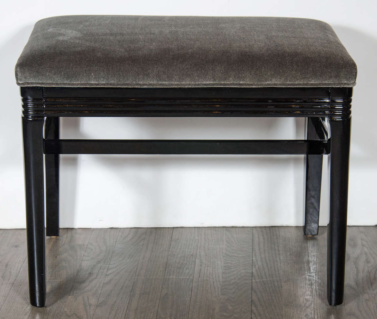 This exceptional Art Deco Machine Age bench / stool features an etched lineal design that runs around the perimeter of the seat, a black lacquer frame with cross supports and newly upholstered seat in smoked grey velvet. Restored to mint condition.