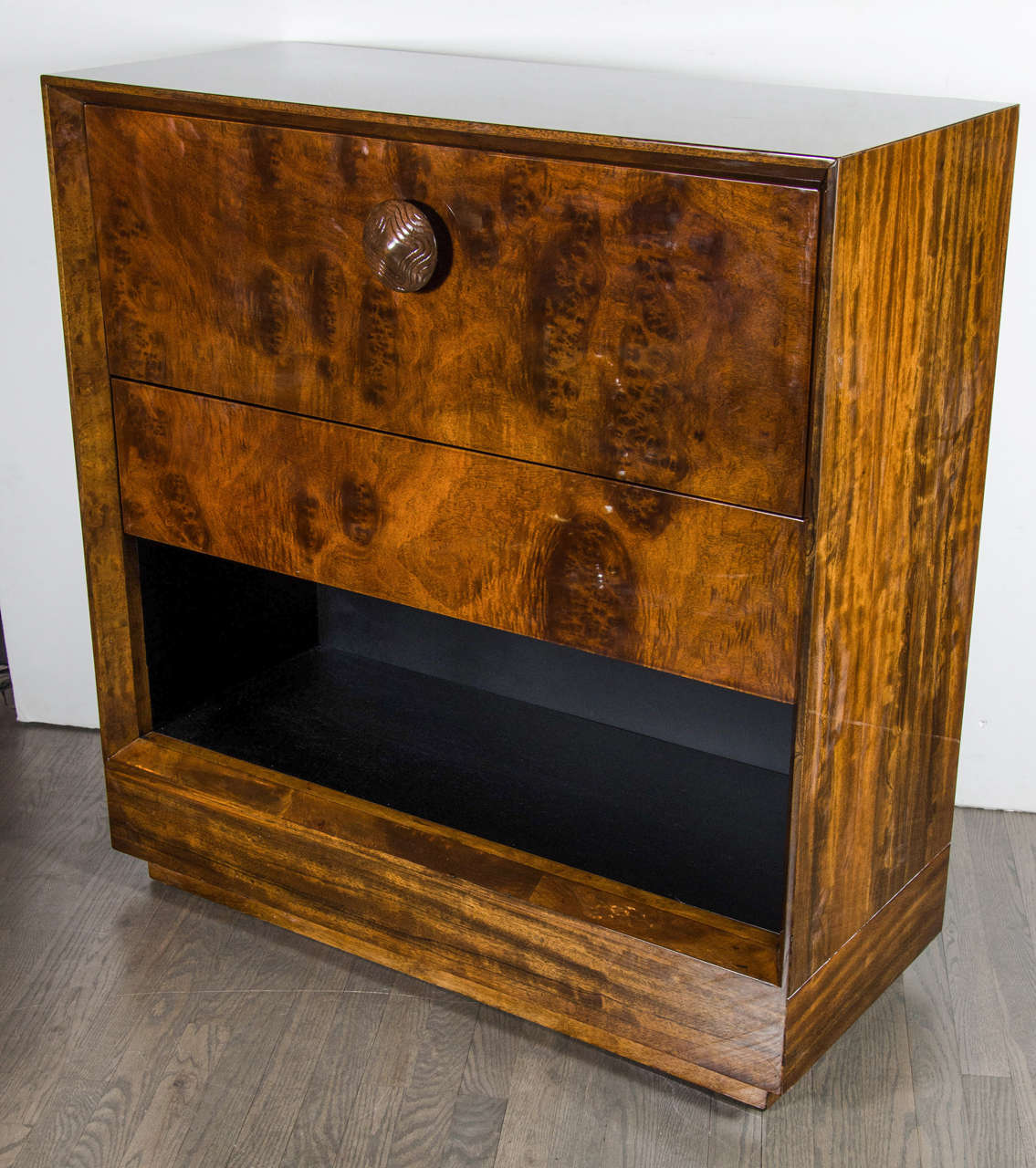 This significant Art Deco secretaire or bar cabinet by Gilbert Rohde features a drop front door which opens to create a serving or writing surface, it has a generous drawer for stowing away accessories and an open niche at the bottom. The
