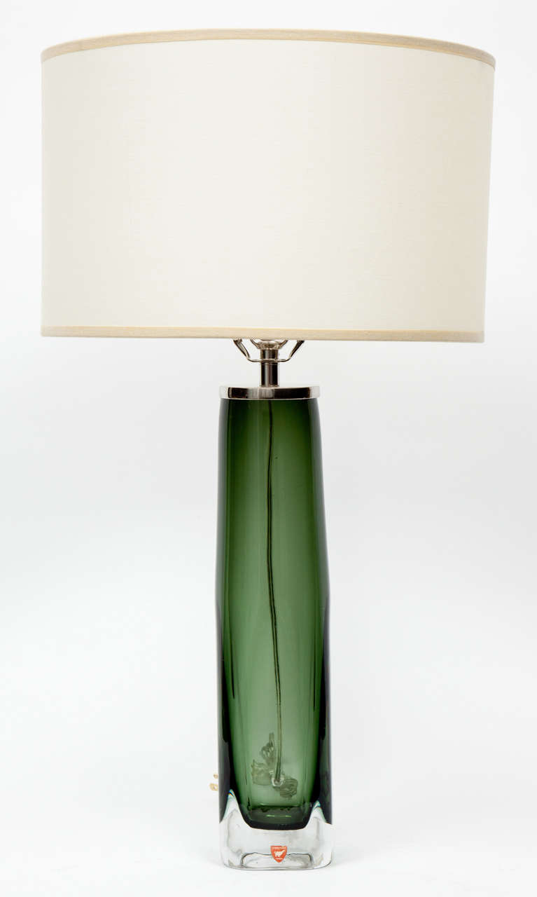 Pair of moss green glass lamps encased in a clear crystal overlay with polished nickel hardware. Rewired for use in the USA. Glass portion measures 14 inches tall.