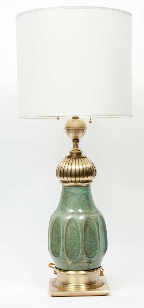 Fantastic pair of jade green glazed ceramic lamps with satin brass fittings and sockets. In the style of Tommi Parzinger.