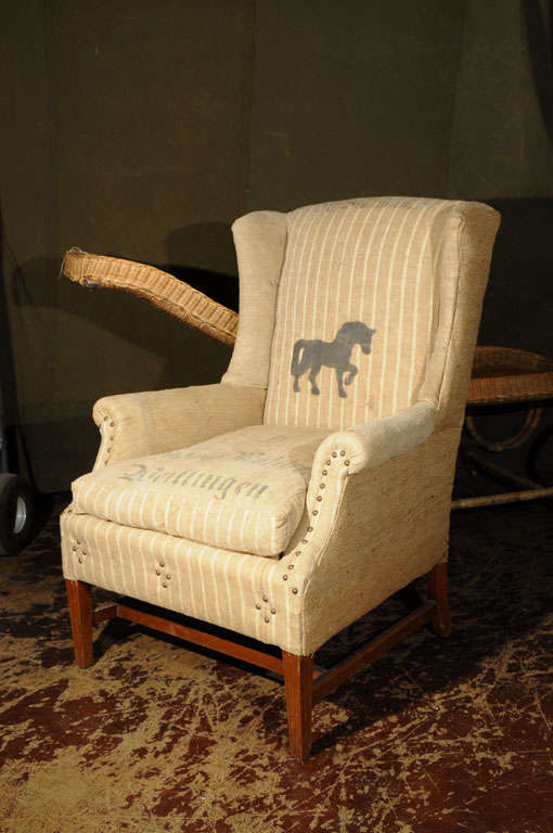 Wing Chair originally constructed in early 1900's covered in European grain sack from 1850's. The grain sack horse motif and graphics were printed in tar based ink.