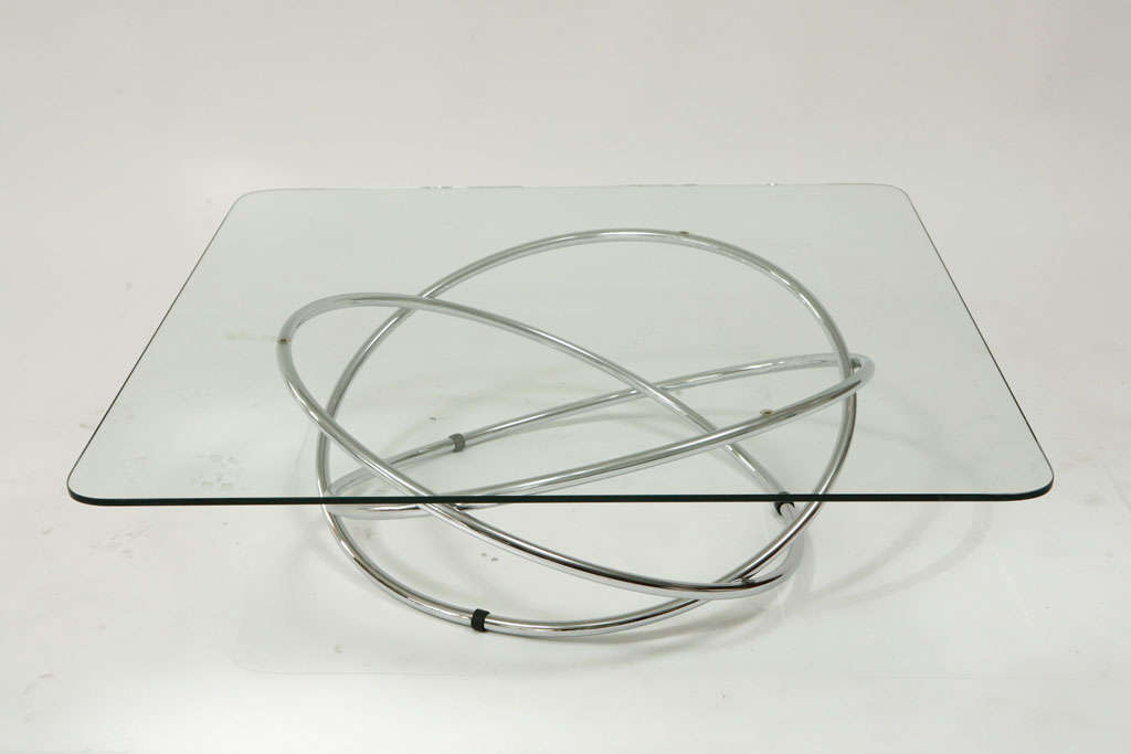 Incredible French chrome coffee table with 3 large circles in an orbit formation. Fantastic curves and sculptural base. Priced without glass.