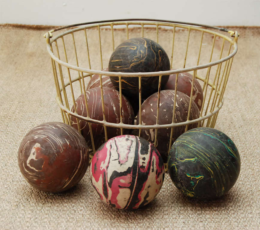 Here is a wonderful group of solid wood marblized bowling balls in an enameled basket. Great colors.