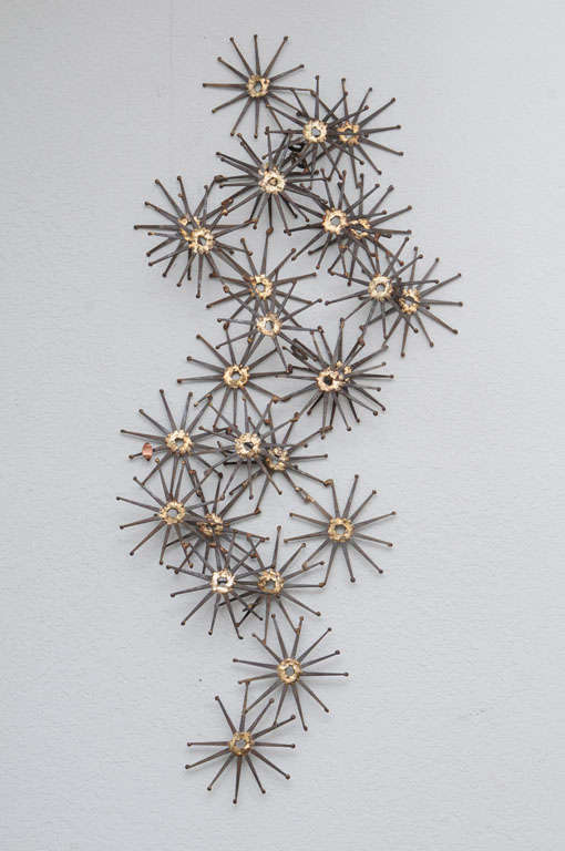 Exuberant Starburst Metal Wall Sculpture, circa 1960's, fashioned from iron nails and gold solder by Willem DeGroot. Signed.