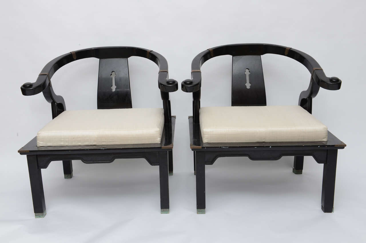 Beautiful pair (2 chairs) of Chinoiserie Chairs by James Mont.  Seats have been recovered in new Duponi silk, black lacquer and brass accents