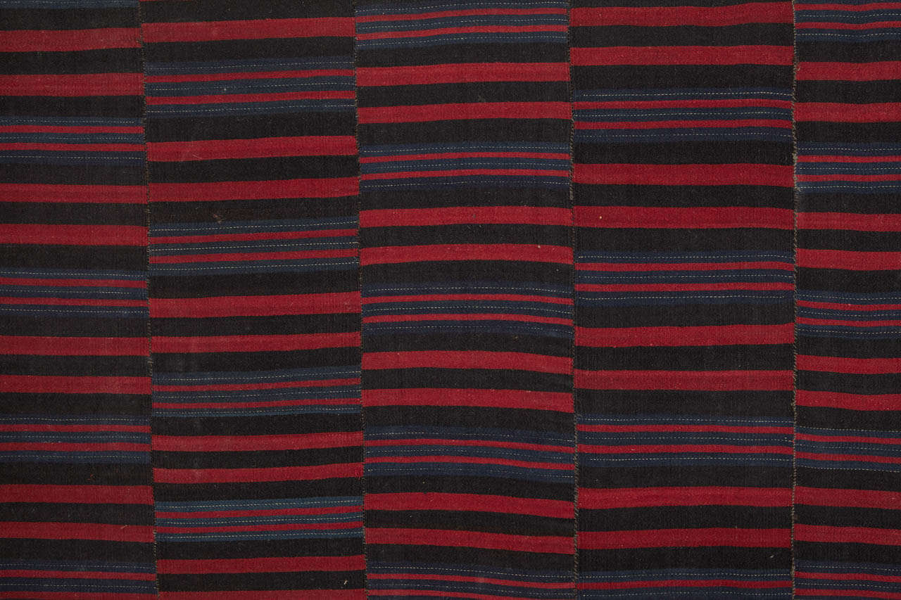 An elegant Tibetan wool textile woven on a back strap loom, composed of five loom width successively joined together. The resulting pattern of slightly offset horizontal lines is a visual delight with a refined modern character. It is mounted with a