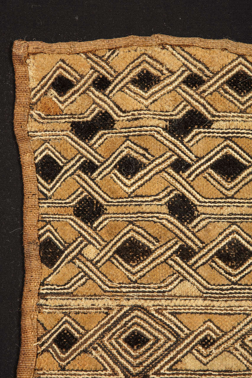 These textiles were woven by the people residing the Kuba kingdom, located in the Democratic Republic of Congo in west central Africa. Skillfully embroidered using a natural fiber such as raffia, examples such as this one were often revered by