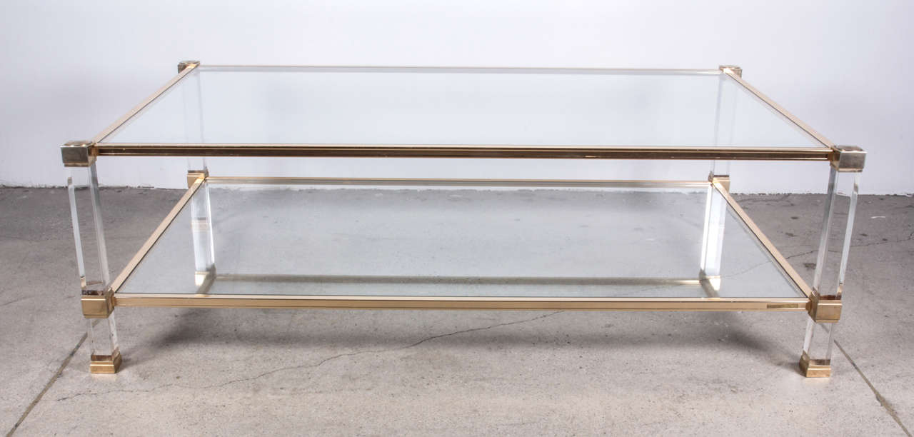 Designed by Pierre Vandel
Rectangular coffee table
Clear Lucite legs
Gilded brass sides 
Signed.