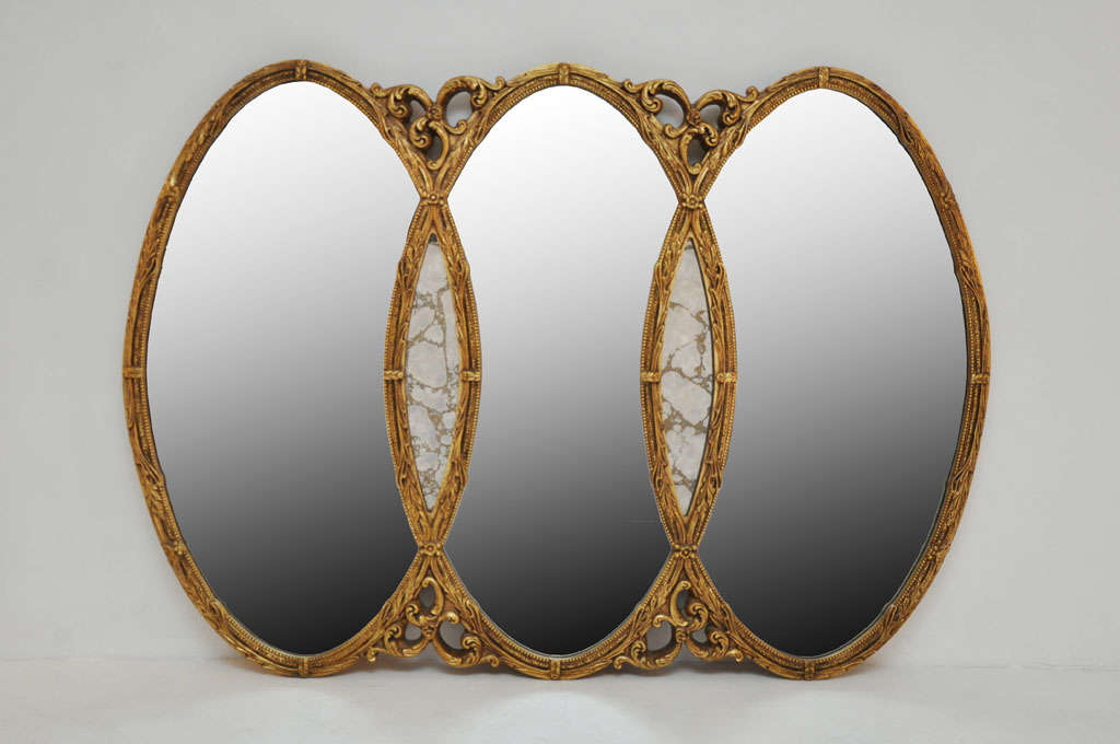 Italian frame with gilt finish.  3 large oval mirrors.  2 smaller Venetian glass mirrors in center.