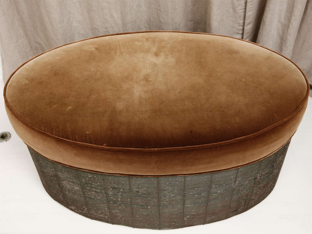 An outstanding piece that plays dual roles as an ottoman and a cocktail table, this design hails from San Francisco, but feels very European. The spun wire of the base is rubbed with a waxy texture, allowing for beautiful coloring and fading over