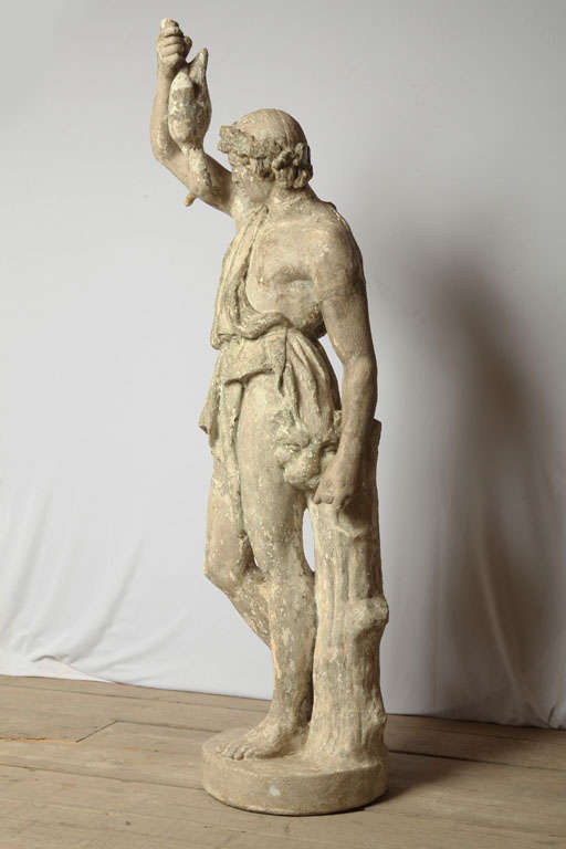 male figure of a greek looking man with his hunting troffee, a duck and a lion's head
