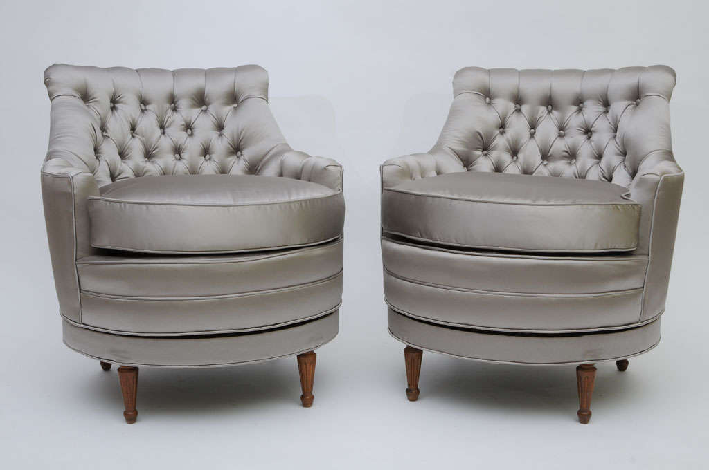 ...SOLD...Rising on Regency/Louis XVI style legs, this pair of tres tufted petite scale slipper chairs are delightful and charming and they swivel.  A low profile scale, they are newly upholstered in an elegant silver grey satin. Thirty button tufts