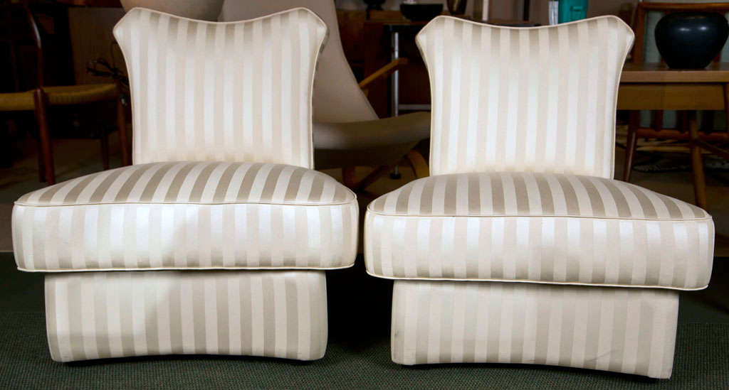 A pair of slipper chairs in the style of James Mont.