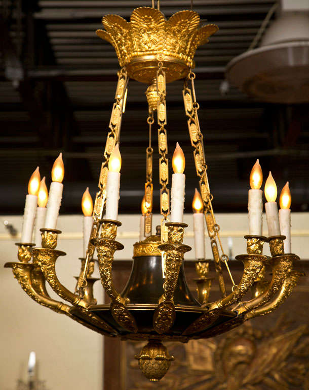 A magnificent twelve-light Empire chandelier having exquisite doré bronze detailing.