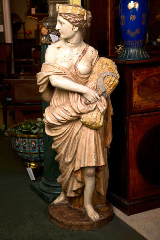 A splendid example of a classically posed French iron statue depicting one of the four seasons ( Autumn ), retaining original paint.