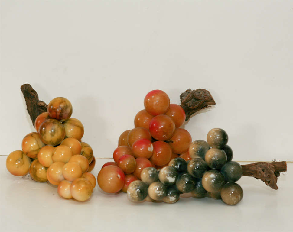 3 bunches of alabaster grapes each with natural wood stems.<br />
Three different colored painted surfaces typical of the period.