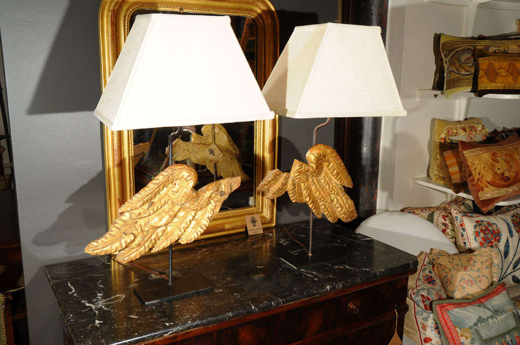 Standing as sculptural pieces of art, these 18th century salvaged Italian angel wings that have been transformed into lamps boast a beautiful gilded finish and are simply striking, especially when illuminated. They are sure to cast the perfect
