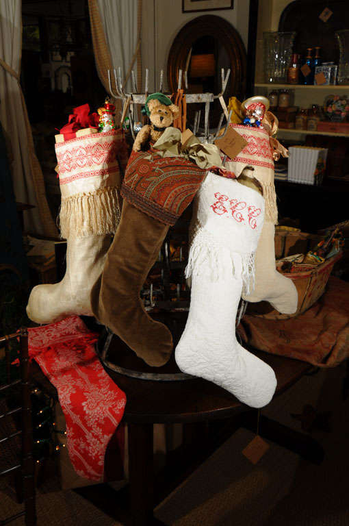 Ring in the joyous season with these beautifully crafted, one of a kind Christmas stockings. Antique tapestry and needlepoint remnants along with vintage textiles are used to create these one of a kind hearth trimmings. Simply inquire for details