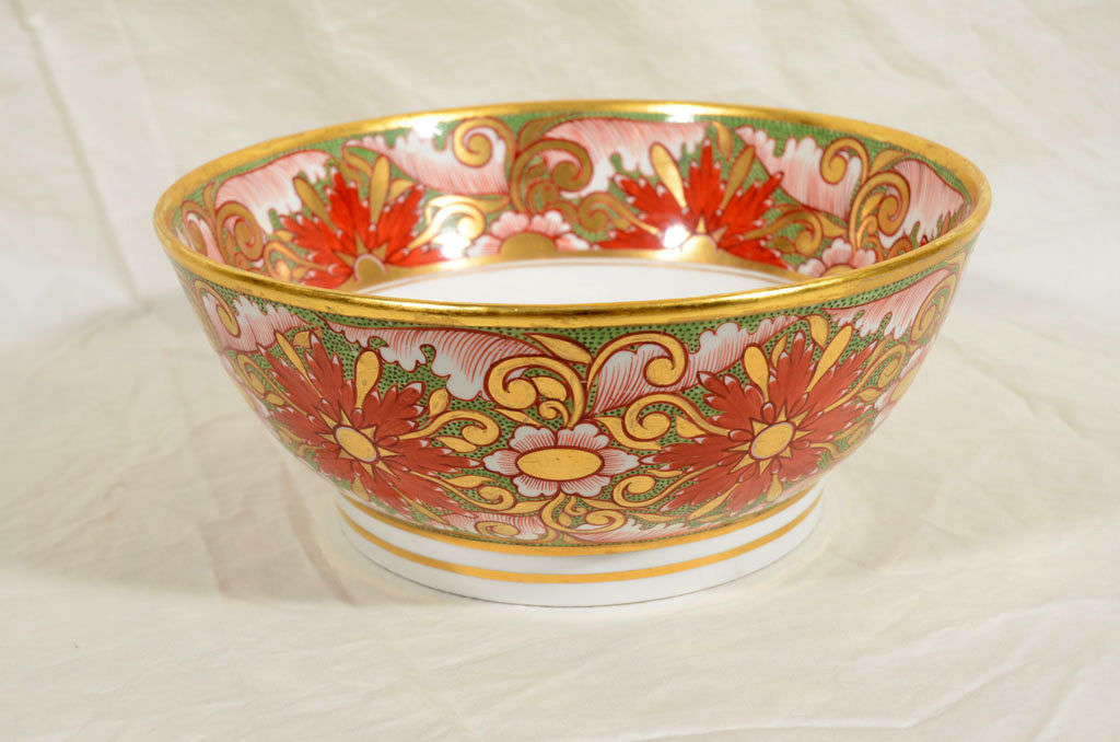 An early 19th century Minton punch bowl boldly painted with iron red starbursts on a green ground all highlighted with rich gilding.
Inside the bowl is a broad border in the same pattern and at the bottom is a starburst (see image #5).