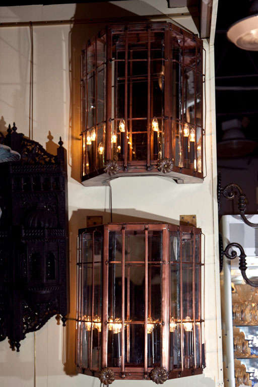 A monumental pair of paneled copper, mirrored back, 8 light sconces having five glass sides with copper grids from a Westport, CT waterfront estate.