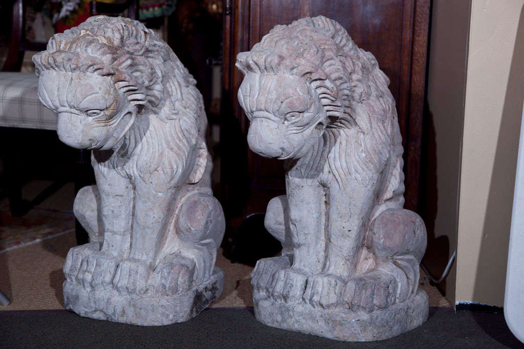 A pair of carved seated stone lions. Origin unknown.  Probably 20th century.

Provenance : The estate of Gianni Versace.