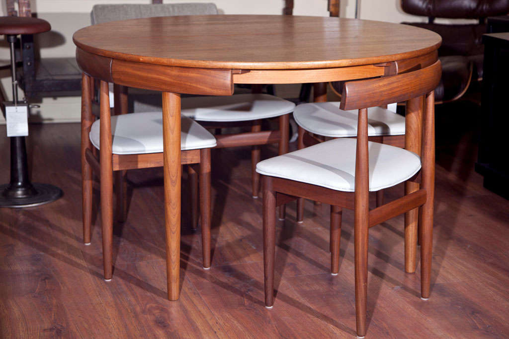 A teak dining set by Danish designer Hans Olsen for Frem Royale with a 20 inch pop up leaf in the center.