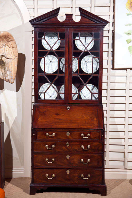 A late George III slant front secretary bookcase with fine figured mahogany. Minor losses / repairs.