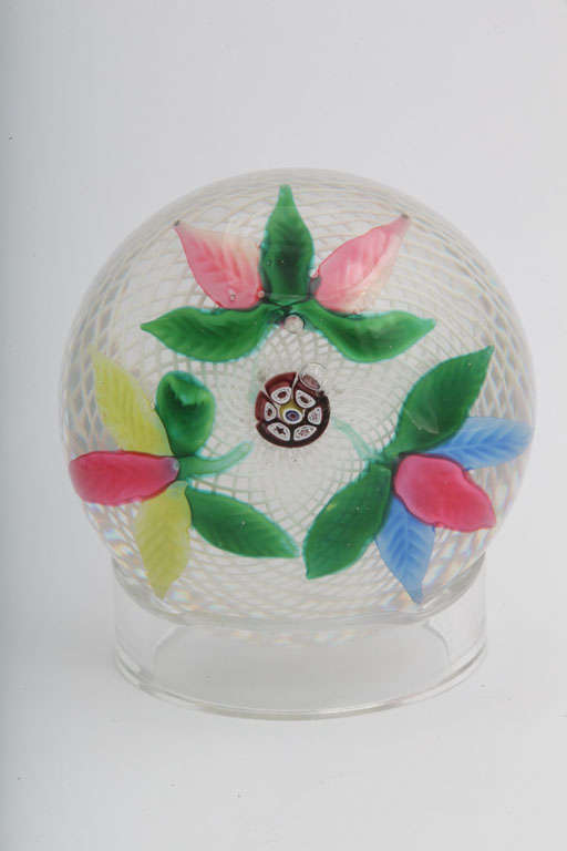 A fine antique New England Glass Company leaf bouquet paperweight on white latticinio, the three leaf designs evenly spaced around a central millefiori cane