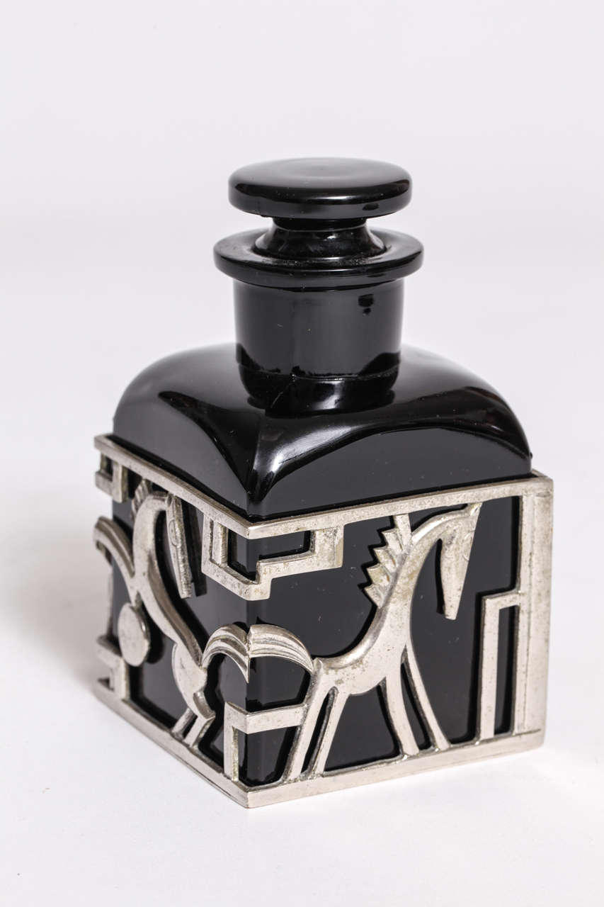 A Karl Hagenauer Art Deco black glass and nickel-plated brass perfume bottle with stylized horses and ponies by Hagenauer Werkstätte, 1928, Austria. Marked with WHW (Hagenauer Werkstatte Wein), made in Austria, patent pending.