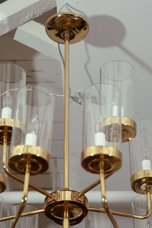 The two-tiered brass fittings, with candle lights and clear glass cylindrical shades.