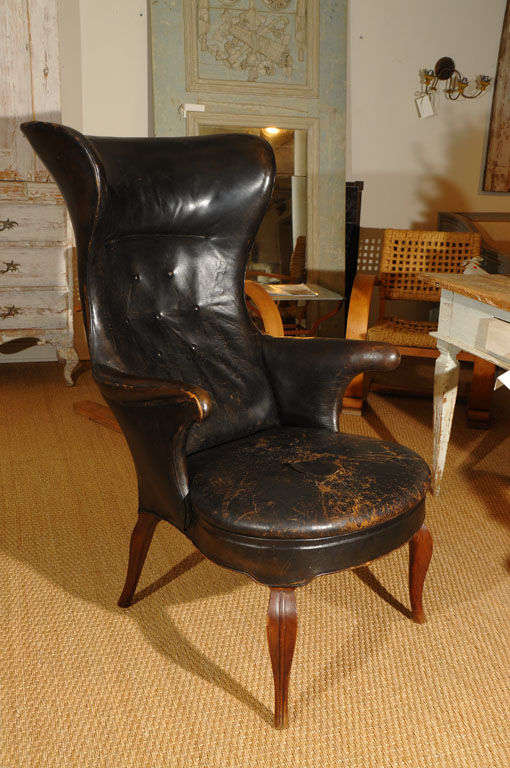 Fritz Henningsen wing chair, circa 1935 with original worn leather upholstery and oak frame with exposed reed detailed 