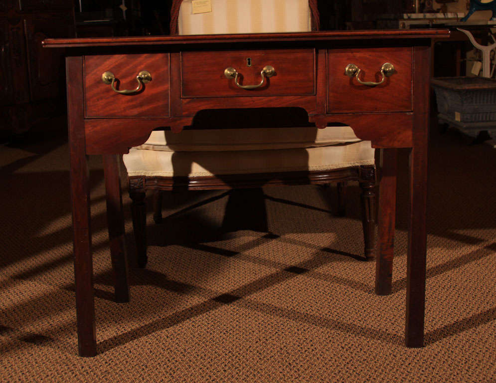 English Georgian Mahogany Lowboy

This wonderful side table is made of Honduran Mahogany and has a medium brown finish.  It features a single board top, square moulded legs and three deep drawers.

The drawers are all original with their