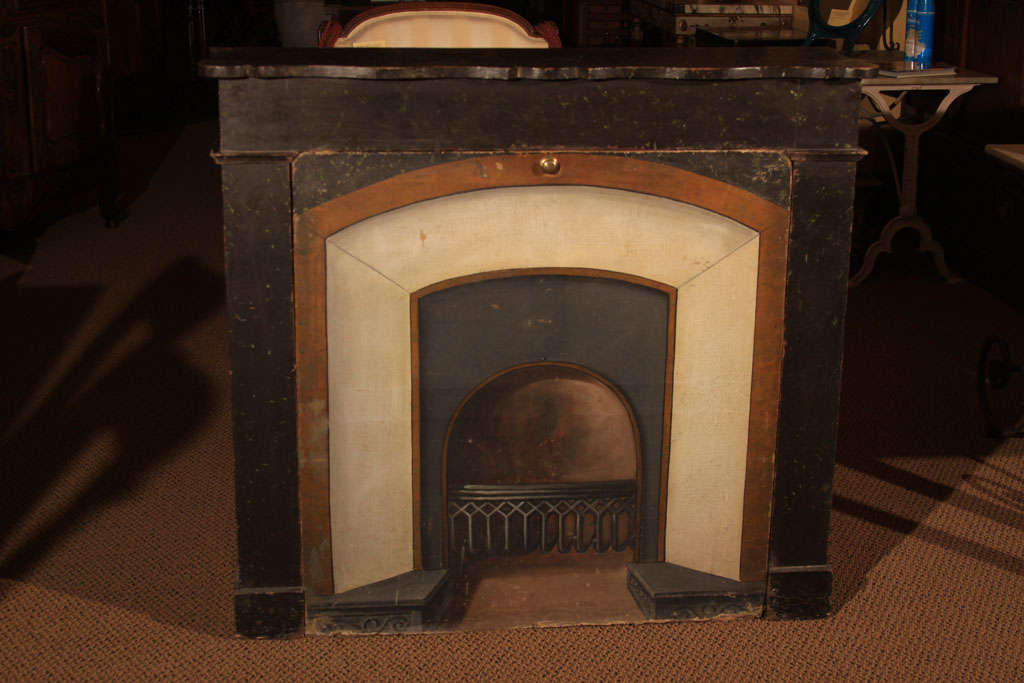 English Trompe l'oeil Fireplace<br />
<br />
This interesting piece is an oil on canvas painting that is inserted into a wooden fireplace frame or mantel.<br />
<br />
The painting can be removed (using the brass knob in the center).<br />
<br