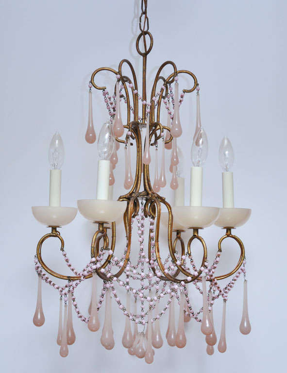 Pale pink opaline glass drops and beads - pretty chandelier with 6 brass arms.  Chandelier has its original brass canopy.