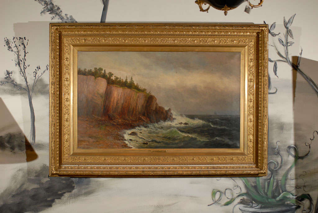 Scenic American landscape painting of waves crashing into a rocky shoreline with boats sailing in the distance by Wesley Webber (1839-1914). <br />
 <br />
Framed in a wonderful water gilt frame with name plate centered beneath painting reading
