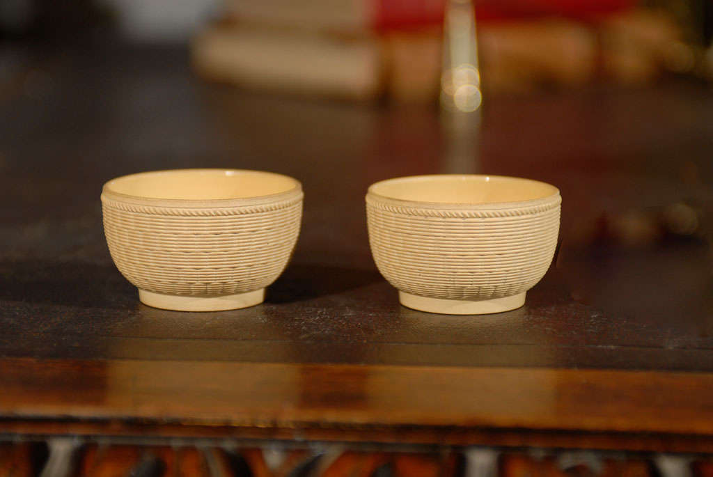 A pair of miniature bowls with basket weave design made by Wedgwood circa 1770-1817. Invented by Josiah Wedgwood (1730-1795), ‘Cane Ware’ was a new kind of fine yellow stoneware which he invented around 1770. The ribbed decoration was done with a