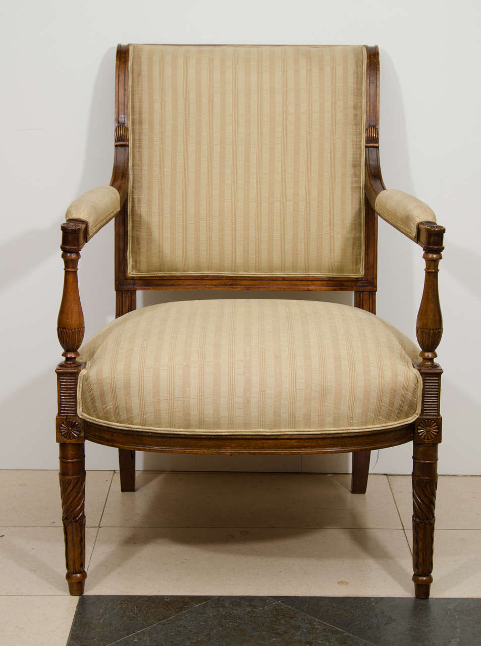 A large pair of French Directoire carved walnut Fauteuil's.