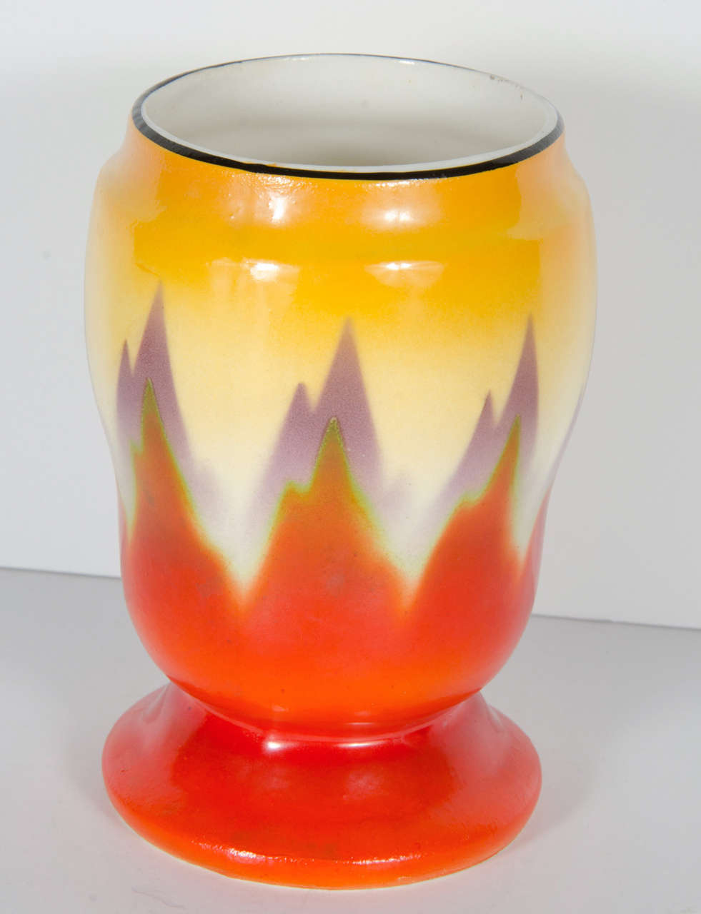 Art Deco vase by Ditmar Urbach from Czechoslovakia, Circa 1930. Hand-painted with hues of red, purple and yellow giving it it's skyscraper flame design.